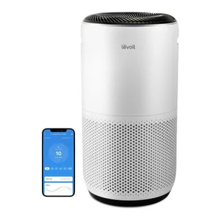 Levoit Core 400S-P air purifier next to a phone showing its app